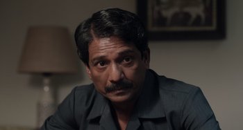 Movie still from “Life of Pi” (2012), directed by Ang Lee – A person sitting in a room; Close Up shot, High angle