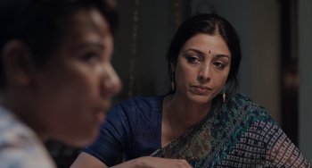Movie still from “Life of Pi” (2012), directed by Ang Lee – A woman sitting next to another woman in front of a mirror; Close Up shot, Over the shoulder angle