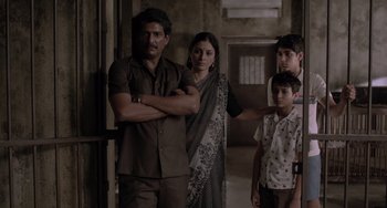 Movie still from “Life of Pi” (2012), directed by Ang Lee – A man and a woman standing next to two children; Medium shot, High angle