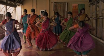 Movie still from “Life of Pi” (2012), directed by Ang Lee – A group of young women in colorful saris dancing; Wide shot, Low angle