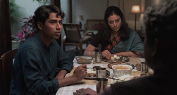 Movie still from “Life of Pi” (2012), directed by Ang Lee – A man and a woman sitting at a dinner table; Medium shot, Over the shoulder angle