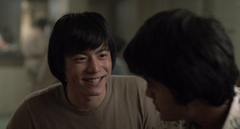 Movie still from “Life of Pi” (2012), directed by Ang Lee – Two young men are talking and smiling at each other; Close Up shot, Over the shoulder angle