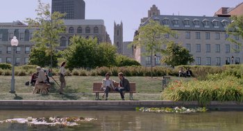Movie still from “Life of Pi” (2012), directed by Ang Lee – Two people sitting on a bench near a body of water; Extreme Wide shot, High angle