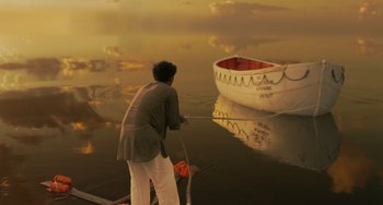 Movie still from “Life of Pi” (2012), directed by Ang Lee – A woman is standing on a boat in the water; Wide shot, High angle