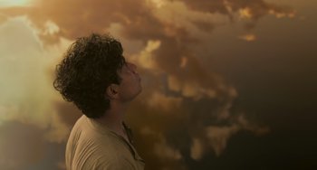 Movie still from “Life of Pi” (2012), directed by Ang Lee – A man looking up into the sky at the clouds; Close Up shot, Low angle