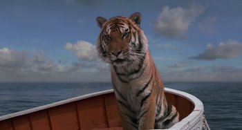 Movie still from “Life of Pi” (2012), directed by Ang Lee – A tiger sitting in a boat; Wide shot, Low angle