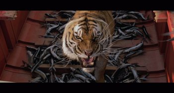 Movie still from “Life of Pi” (2012), directed by Ang Lee – A tiger's face with a pile of dead fish behind it; Wide shot, Low angle