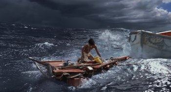 Movie still from “Life of Pi” (2012), directed by Ang Lee – A man is sitting on a raft in the ocean; Extreme Wide shot, Low angle