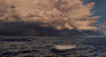 Movie still from “Life of Pi” (2012), directed by Ang Lee – A boat floating in the ocean under a cloudy sky; Extreme Wide shot, High angle