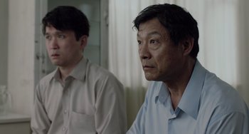 Movie still from “Life of Pi” (2012), directed by Ang Lee – Two men sitting in front of each other in a room; Close Up shot, Over the shoulder angle