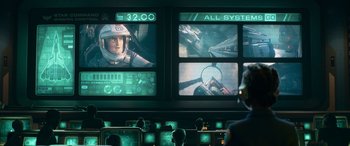 Movie still from “Lightyear” (2022), directed by Angus MacLane – A group of people standing in front of a screen; Wide shot, Over the shoulder angle