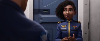 Movie still from “Lightyear” (2022), directed by Angus MacLane – A woman in a uniform is looking surprised at something; Medium shot, Over the shoulder angle