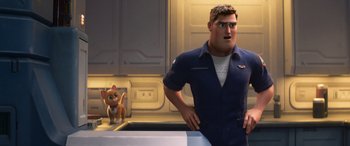 Movie still from “Lightyear” (2022), directed by Angus MacLane – A man standing next to a cat in a kitchen; Medium shot, Over the shoulder angle