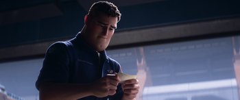 Movie still from “Lightyear” (2022), directed by Angus MacLane – A man writing on a piece of paper in front of a window; Close Up shot, Over the shoulder angle
