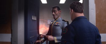 Movie still from “Lightyear” (2022), directed by Angus MacLane – A man in a uniform is talking to another man in a uniform; Medium shot, Over the shoulder angle