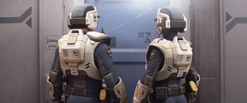 Movie still from “Lightyear” (2022), directed by Angus MacLane – A couple of people that are standing next to each other; Medium shot, Over the shoulder angle