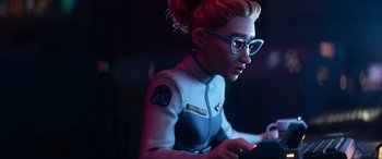 Movie still from “Lightyear” (2022), directed by Angus MacLane – A woman with glasses is playing a video game; Medium shot, Over the shoulder angle