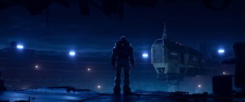 Movie still from “Lightyear” (2022), directed by Angus MacLane – An image of a man standing in front of a building at night; Wide shot, Low angle