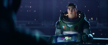 Movie still from “Lightyear” (2022), directed by Angus MacLane – A man in a space suit is holding a device; Medium shot, Over the shoulder angle