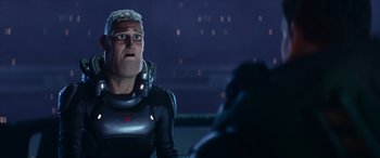 Movie still from “Lightyear” (2022), directed by Angus MacLane – A man in a black suit is talking to someone; Close Up shot, Over the shoulder angle