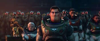 Movie still from “Lightyear” (2022), directed by Angus MacLane – A group of people in a room with a man in a space suit; Medium shot, Low angle