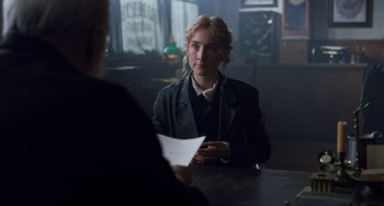 Movie still from “Little Women” (2019), directed by Greta Gerwig – A woman sitting at a table in front of a man; Medium shot, Over the shoulder angle