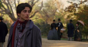 Movie still from “Little Women” (2019), directed by Greta Gerwig – A young man in a long coat and a hat; Close Up shot, Over the shoulder angle
