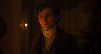 Movie still from “Little Women” (2019), directed by Greta Gerwig – A young man wearing a brown jacket and a white shirt; Close Up shot, Over the shoulder angle
