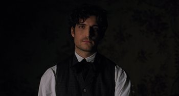 Movie still from “Little Women” (2019), directed by Greta Gerwig – A man wearing a vest and a black tie; Close Up shot, Low angle