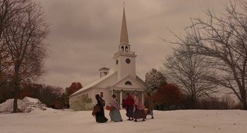 Movie still from “Little Women” (2019), directed by Greta Gerwig – A group of people walking in front of a white church; Extreme Wide shot, Low angle