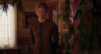 Movie still from “Little Women” (2019), directed by Greta Gerwig – An older woman standing in front of a christmas tree; Medium shot, Over the shoulder angle