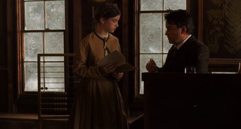 Movie still from “Little Women” (2019), directed by Greta Gerwig – A man and a woman are standing in front of a window; Medium shot, Over the shoulder angle