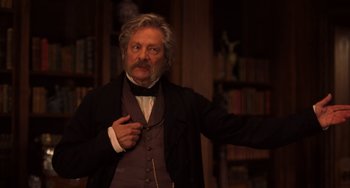 Movie still from “Little Women” (2019), directed by Greta Gerwig – An older man in a suit and a tie; Medium shot, Low angle