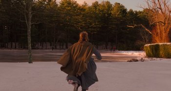 Movie still from “Little Women” (2019), directed by Greta Gerwig – A woman walking in the snow with a dog; Extreme Wide shot, Over the shoulder angle
