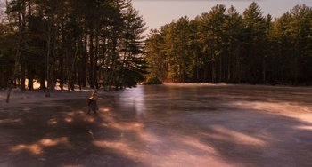 Movie still from “Little Women” (2019), directed by Greta Gerwig – A person standing on a frozen lake near a forest; Extreme Wide shot, High angle