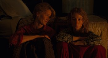 Movie still from “Little Women” (2019), directed by Greta Gerwig – Two women sitting on a couch looking at each other; Close Up shot, High angle