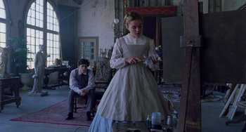 Movie still from “Little Women” (2019), directed by Greta Gerwig – A young girl in a white dress standing in front of a painting; Medium shot, Low angle