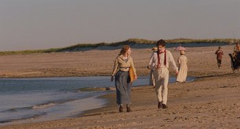 Movie still from “Little Women” (2019), directed by Greta Gerwig – A man and a woman walking on the beach; Wide shot, Over the shoulder angle