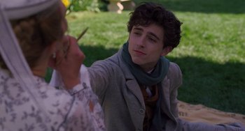 Movie still from “Little Women” (2019), directed by Greta Gerwig – A young man sitting on the grass next to a woman; Close Up shot, Over the shoulder angle