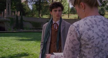 Movie still from “Little Women” (2019), directed by Greta Gerwig – A young man wearing a suit and a tie talking to an older woman; Medium shot, Over the shoulder angle