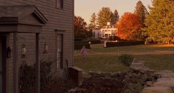 Movie still from “Little Women” (2019), directed by Greta Gerwig – A person walking in a yard near a house; Extreme Wide shot, High angle