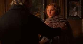 Movie still from “Little Women” (2019), directed by Greta Gerwig – A man and a woman standing next to each other in front of a window; Medium shot, Over the shoulder angle