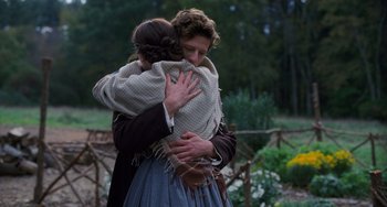 Movie still from “Little Women” (2019), directed by Greta Gerwig – A man and a woman embracing each other in a wooded area; Medium shot, Over the shoulder angle