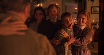 Movie still from “Little Women” (2019), directed by Greta Gerwig – A group of people standing next to each other in a room; Medium shot, Over the shoulder angle