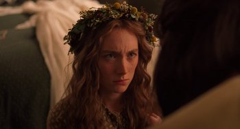 Movie still from “Little Women” (2019), directed by Greta Gerwig – A woman with long red hair wearing a flower crown; Close Up shot, Over the shoulder angle