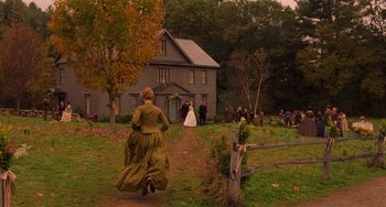 Movie still from “Little Women” (2019), directed by Greta Gerwig – A woman in a green dress running down a dirt road; Extreme Wide shot, High angle