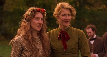 Movie still from “Little Women” (2019), directed by Greta Gerwig – Two women standing next to each other in front of a forest; Close Up shot, Over the shoulder angle