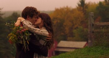 Movie still from “Little Women” (2019), directed by Greta Gerwig – A man and a woman are kissing in a field; Medium shot, Over the shoulder angle