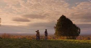 Movie still from “Little Women” (2019), directed by Greta Gerwig – Two people standing on top of a hill looking at a tree; Extreme Wide shot, Over the shoulder angle