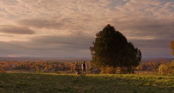 Movie still from “Little Women” (2019), directed by Greta Gerwig – A couple of people standing on top of a grass covered field; Extreme Wide shot, Over the shoulder angle